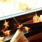 Fensterbank mit Kerzen und Sternenlichterkette