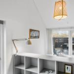 Room with white walls, desk, bed, and windows to the terrace.