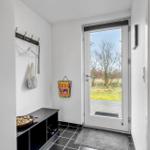 Entrance area with shoe cabinet, hooks, and glass door to the outside.