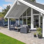 Terrace with seating, table, and hot tub under roof