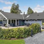 A modern house with terrace, garden and barbecue area. Backyard with seating areas.