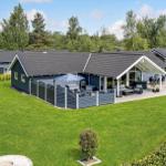 Modern vacation home with large garden and terrace with seating areas.