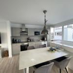 Kitchen with dining area, modern built-in kitchen, and large window