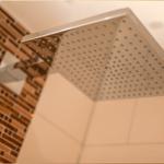 Große Duschkopf mit mehreren Düsen und Backsteinwand im Badezimmer
