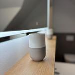 A white-gray fan sits on a wooden surface.