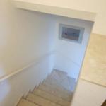 Staircase with handrail and wall picture in hallway