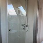 Shower enclosure with showerhead and skylight