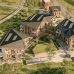 Moderne Gebäude mit Solaranlagen und Grünflächen. Nah am Bahnhof und Parkplatz.