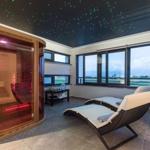 Sauna with star ceiling and loungers with view of landscape