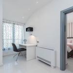 Bedroom with bed, desk, and bathroom