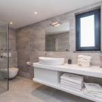 Bathroom with shower, sink, and window