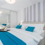 Bedroom with bed, wardrobe, and striped wall