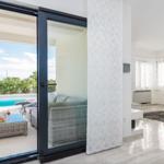 Terrace with pool and lounge area. Living room with sofa and rug.