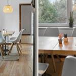 Essbereich mit Holztisch, weißen Stühlen und Fensterblick auf Grün