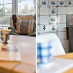 Sitzgelegenheit mit Kissen vor Fenster und Kamin mit Segelbootfliesen