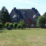 House with dark roof, garden table, and clothesline in the yard