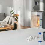 Kitchen with counter, living room with fireplace and sofa in background.