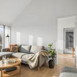 Living room with sofa, coffee table, and view of garden.