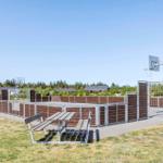 Outdoor play area with basketball hoop, soccer goal, and picnic table.