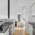 Kitchen with white cabinets, dark countertops, and integrated dishwasher area.