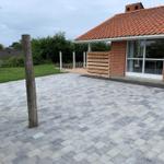Large paved yard with terrace and shed next to the house.
