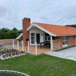 House with terrace, barbecue area, and large chessboard in the garden.