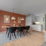 Dining area with table, chairs, and wall posters. Kitchen with countertop and cabinets.