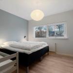 Bedroom with double bed, child bed, window, and wardrobe.