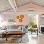 Living room with sofa, coffee table, and view of garden