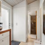 Kitchen with coffee machine, cabinet, and view into the bathroom.