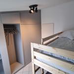 Ein Schlafzimmer mit einem Doppelstockbett und einem Kleiderschrank.