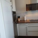 Kitchen with white countertop and stainless steel appliances.