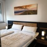 Bedroom with double bed, nightstand, and wall art