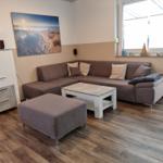 Living room with corner sofa, coffee table, and wooden floor.
