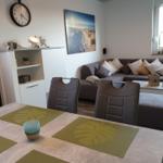 Dining area with table and chairs. Living area with sofa and coffee table.