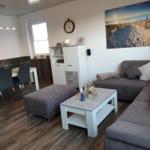 Living and dining area with sofa, table, and wall art