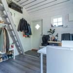 Raum mit Treppe, Kleiderständer, Schuhschrank und Tisch mit Stühlen.