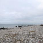 Steiniger Strand mit Bootssteg direkt am Wasser