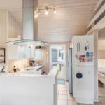 Kitchen with dining area and bedroom in the background.
