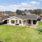 House with large garden, playground, and terrace. View of surrounding houses and trees.