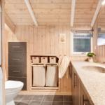 Bathroom with washing machine, toilet, and sink