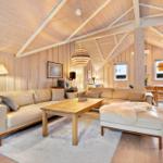 Living room with wooden ceiling, sofa and dining table