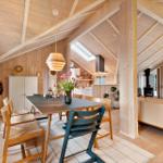 Dining area with table, chairs, and view into kitchen and living room