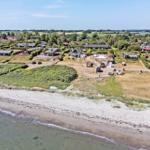 Coastal residential area with construction site and green meadows