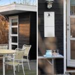 House with terrace, table and chairs. Door with drink tray and dog sign.