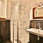 Bad mit Dusche, Waschbecken und Spiegel