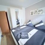 Bedroom with double bed, wardrobe, and wall art.