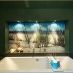 Bad mit Badewanne, Wandbild Strand und Kerzen.