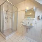 Bath with shower, sink and mirror