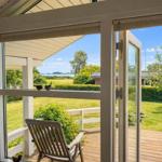 Through the glass door, the view opens to the terrace and garden.